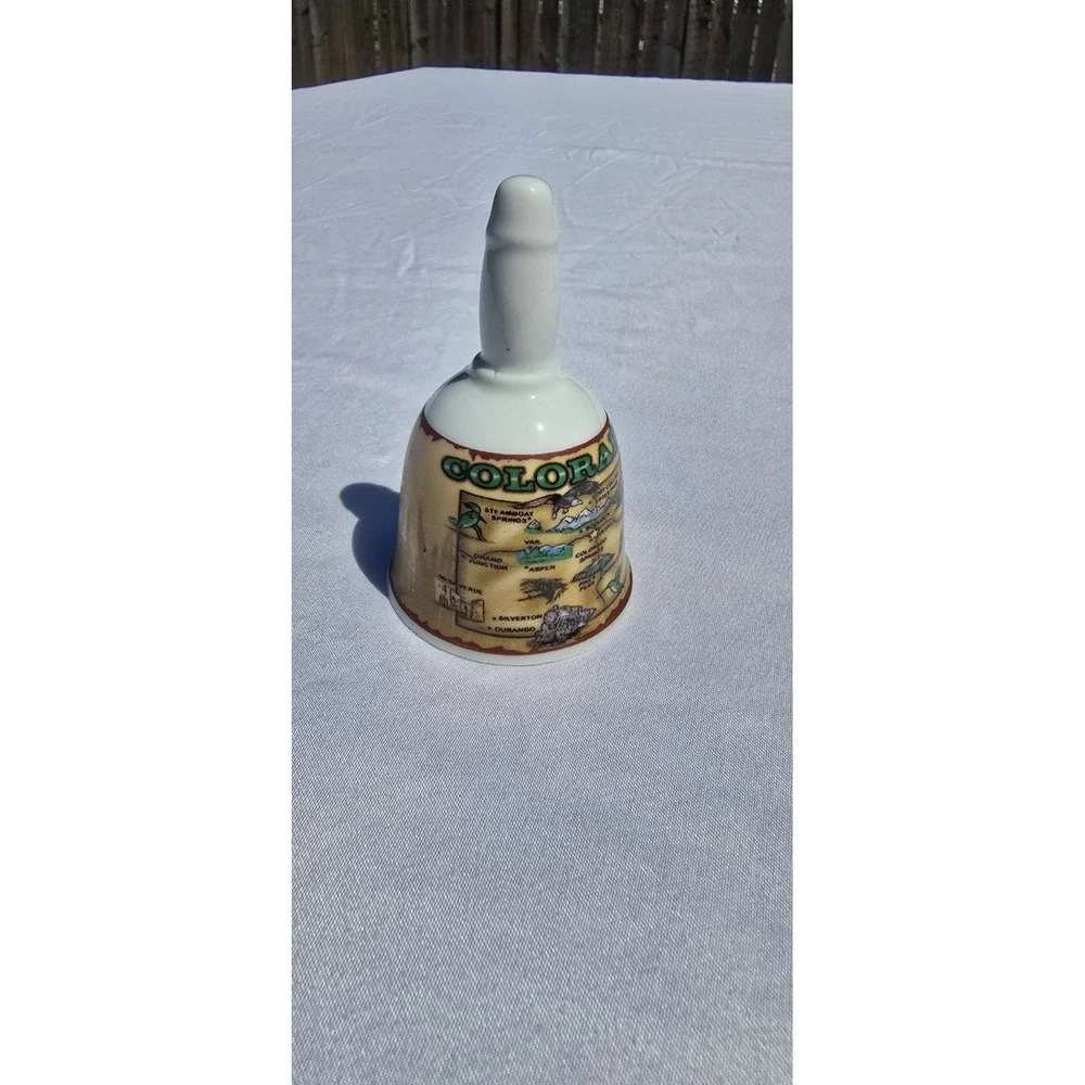 vintage/collectible porcelain souvenir bell featuring a map graphic of Colorado